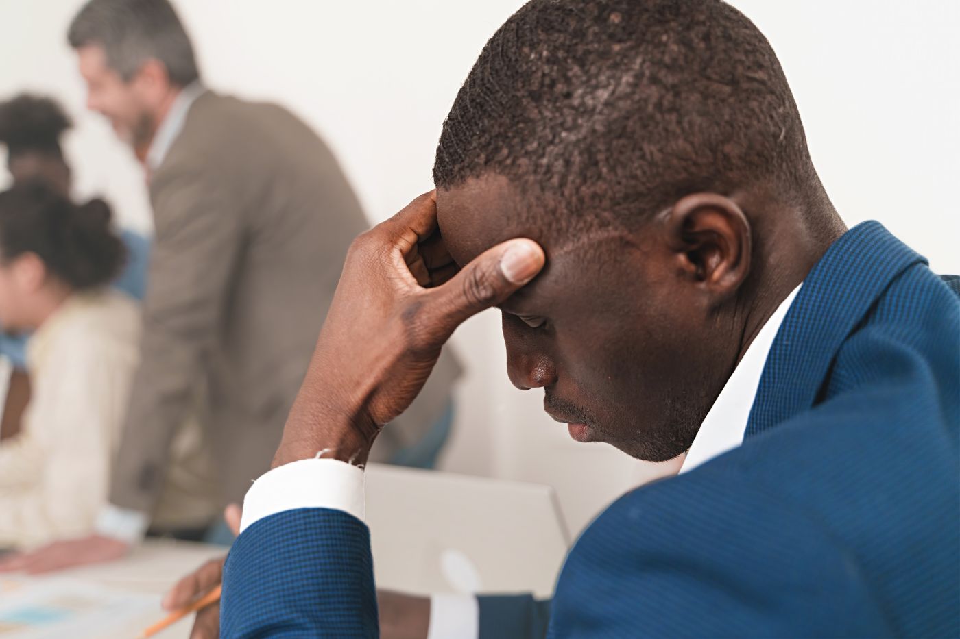 African Businessman With Headache In Office - Auster Inteligência Contábil