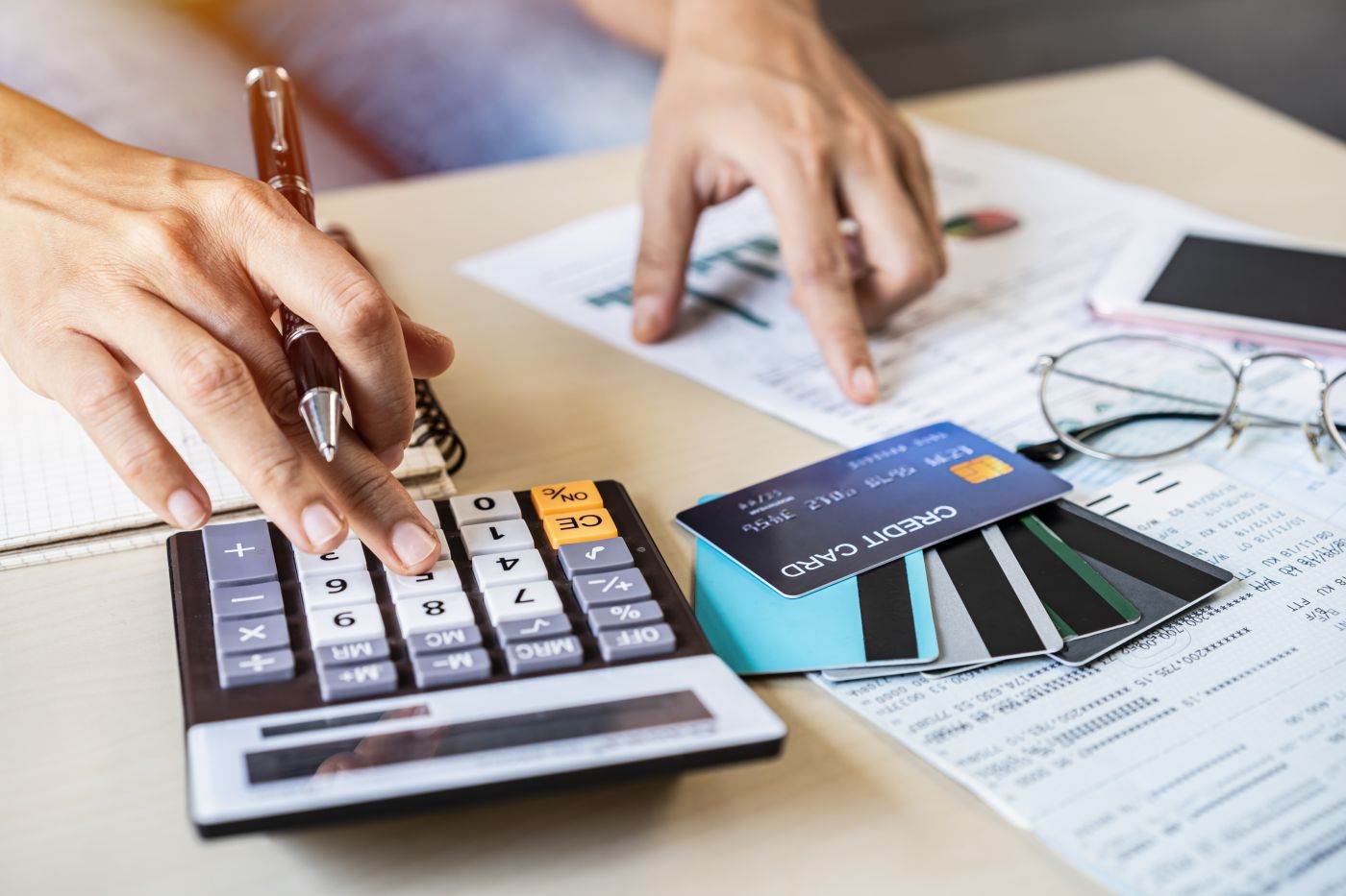 Young Woman Checking Bills, Taxes, Bank Account Balance And Calculating Credit Card Expenses At Home - Auster Inteligência Contábil