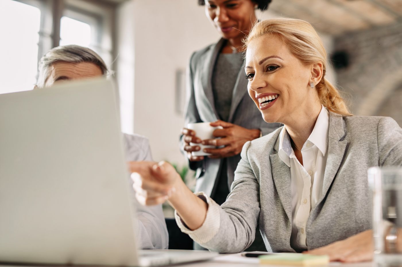 Happy Businesswoman Using Laptop On A Meeting At The Office. - Auster Inteligência Contábil