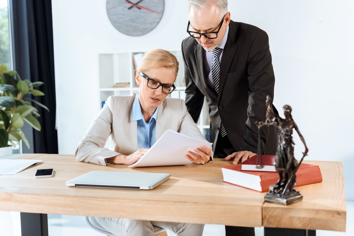 Serious Mature Lawyers With Paperwork In Modern Office - Auster Inteligência Contábil