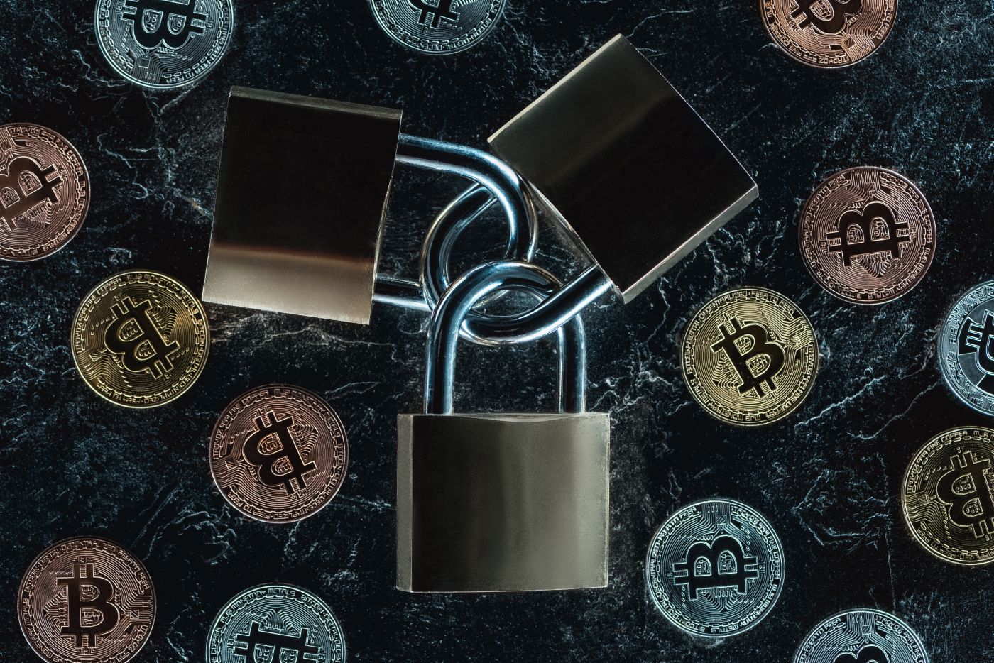 Top View Of Arranged Locks And Various Bitcoins On Dark Marble Surface - Auster Inteligência Contábil